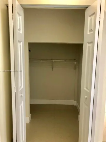 a view of a yard with a fountain and a large tree