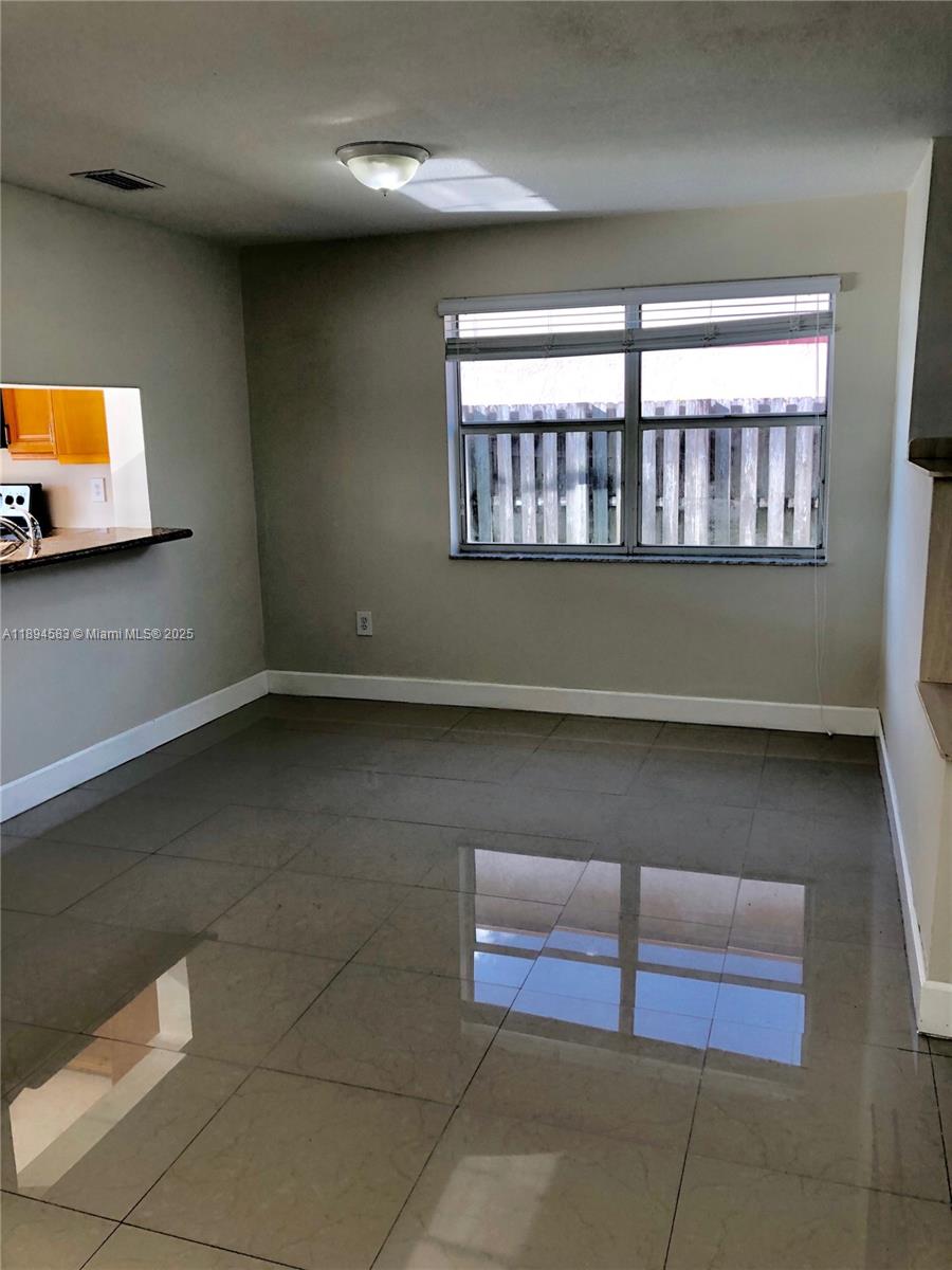 1010 Southwest 99th Avenue Pembroke Pines, FL 33025 - Photo 4 of 22 a view of an empty room with a window