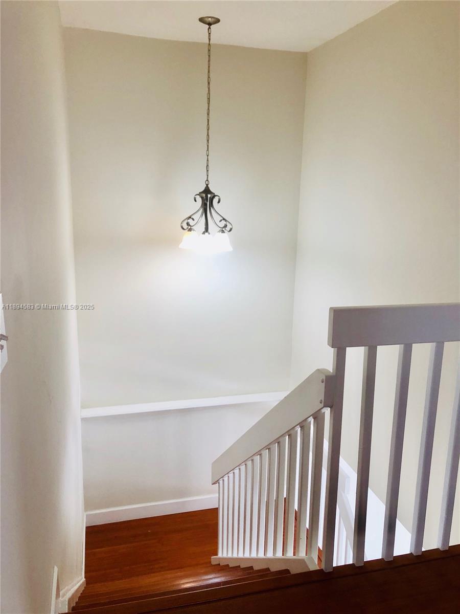 1010 Southwest 99th Avenue Pembroke Pines, FL 33025 - Photo 10 of 22 a view of a hallway with a chandelier