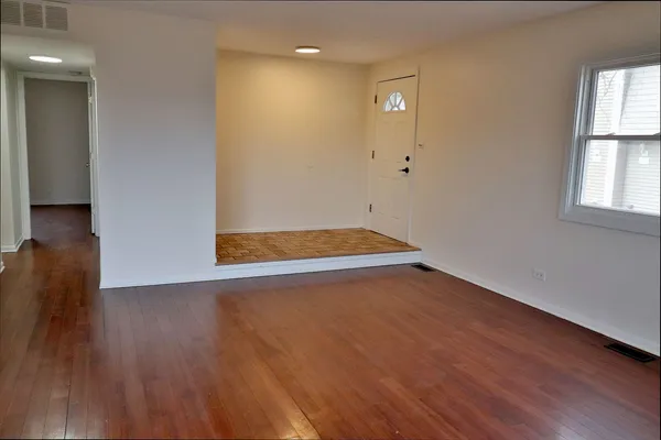 a view of room with wooden floor and window