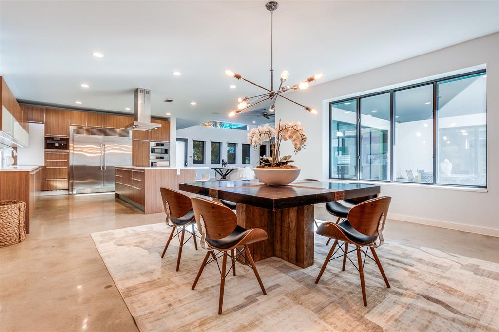 9317 Midway Road Dallas, TX 75220 - Photo 16 of 30 a dining room with furniture a chandelier and wooden floor