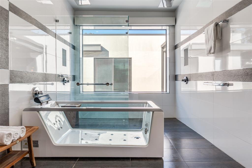 9317 Midway Road Dallas, TX 75220 - Photo 20 of 30 a bathroom with a sink a mirror and a bathtub