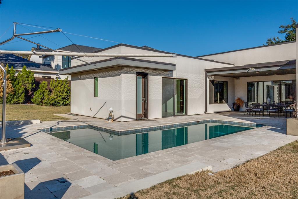 9317 Midway Road Dallas, TX 75220 - Photo 26 of 30 a view of a white house with swimming pool in front of it