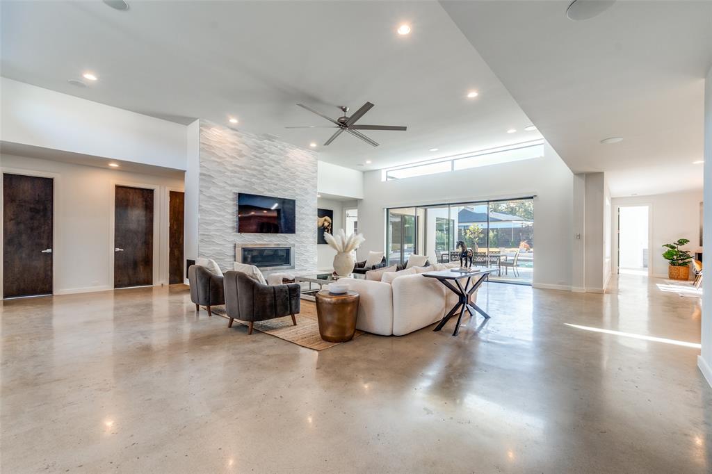 9317 Midway Road Dallas, TX 75220 - Photo 5 of 30 a living room with fireplace furniture and a flat screen tv