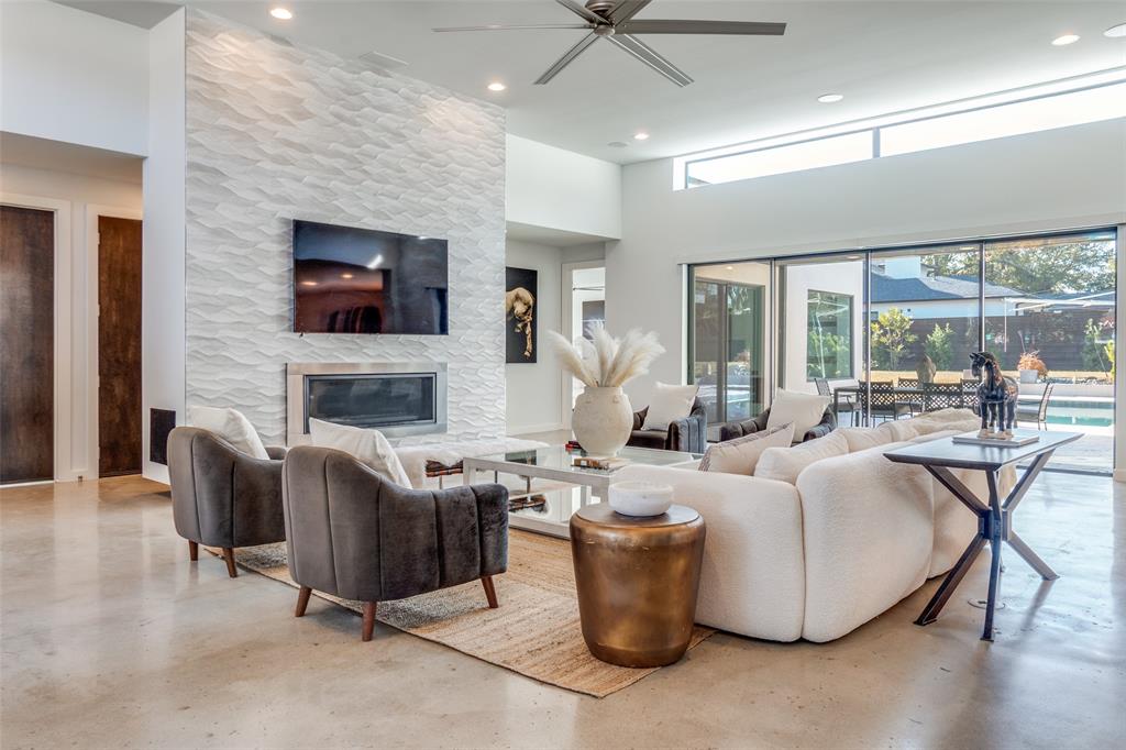9317 Midway Road Dallas, TX 75220 - Photo 8 of 30 a living room with fireplace furniture and a flat screen tv