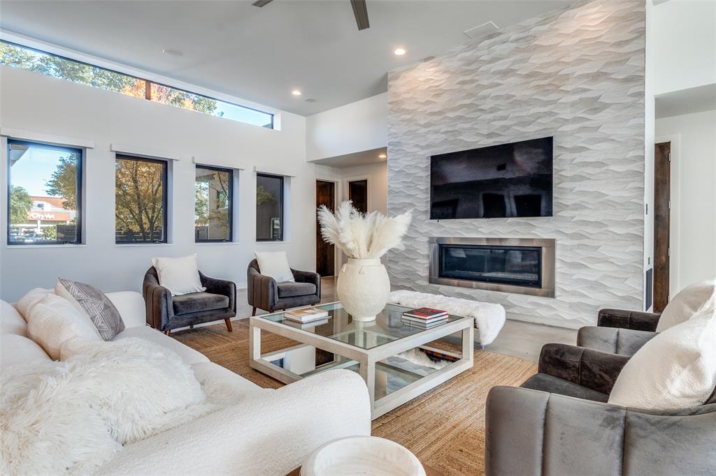 9317 Midway Road Dallas, TX 75220 - Photo 9 of 30 a living room with furniture a flat screen tv and a fireplace