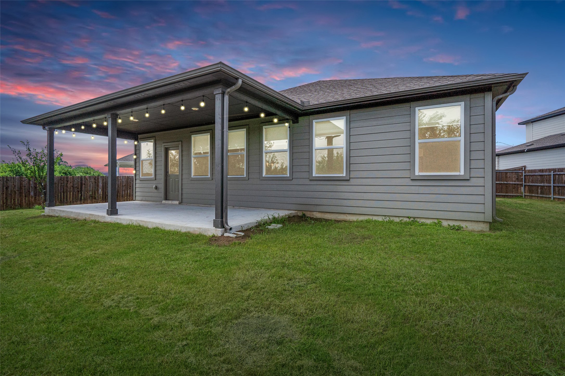 104 Stinchcomb Road Hutto, TX 78634 - Photo 33 of 40 Step outside to enjoy a large covered patio, fruit trees, an oversized backyard, and a peaceful greenbelt backdrop that makes the outdoor space feel both private and rare.