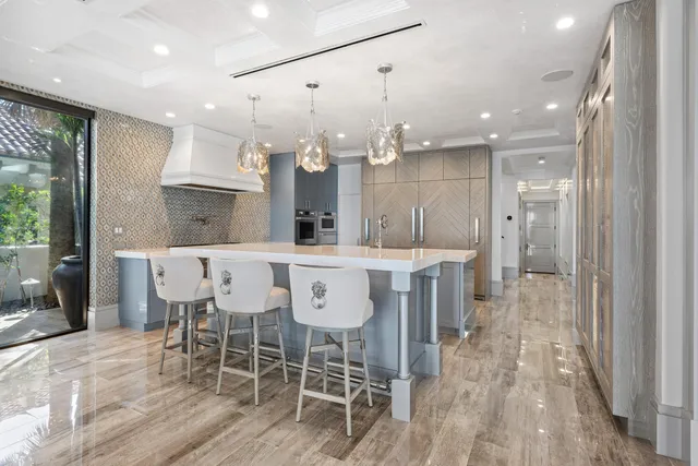 a bedroom with a bed a couch and large window