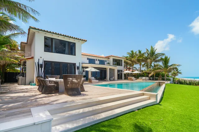 a view of a dining room with furniture a chandelier and wooden floor