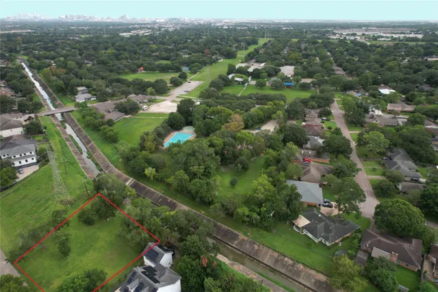 a green field with lots of trees in it