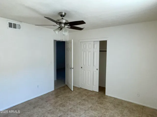 an empty room with a ceiling fan