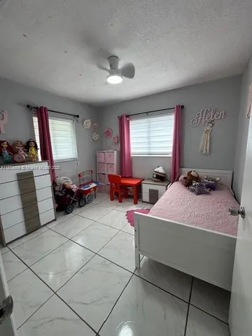 a spacious bedroom with a bed and window