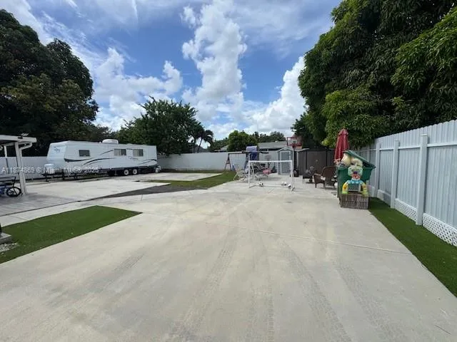 a view of outdoor space with seating area and trees around