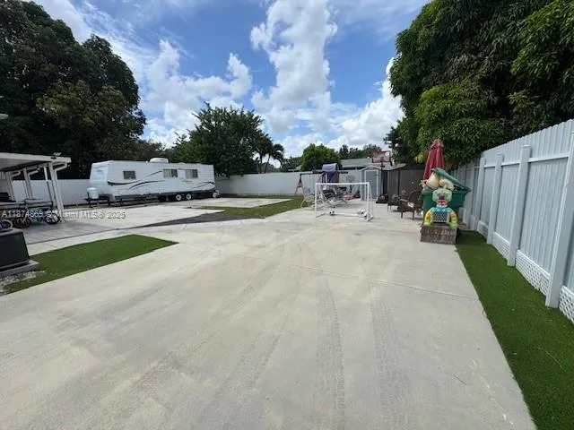 a view of a backyard patio and swimming pool