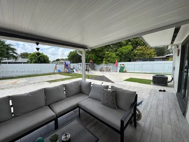 a view of swimming pool with a couches in a patio