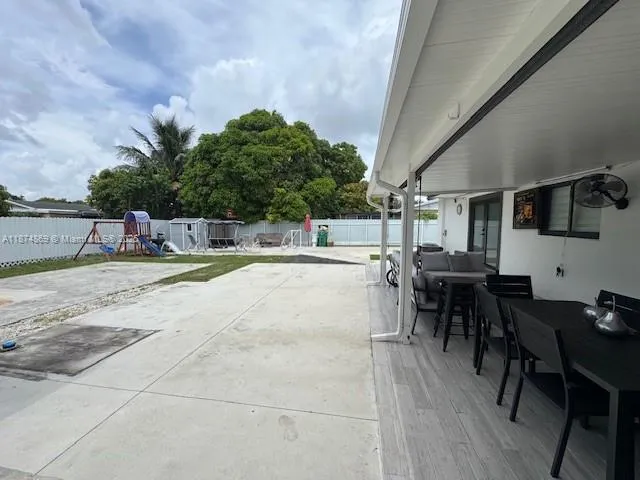 a view of a dinning table and chairs in the patio