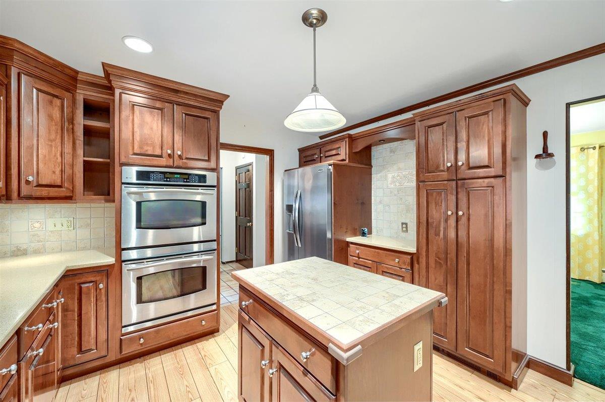 129 Barnes Road Washingtonville, NY 10992 - Photo 14 of 48 a kitchen with stainless steel appliances granite countertop a refrigerator a stove and a sink with wooden floor