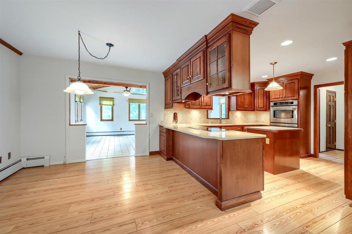 129 Barnes Road Washingtonville, NY 10992 - Photo 15 of 48 a kitchen with stainless steel appliances granite countertop a sink counter space cabinets and wooden floor