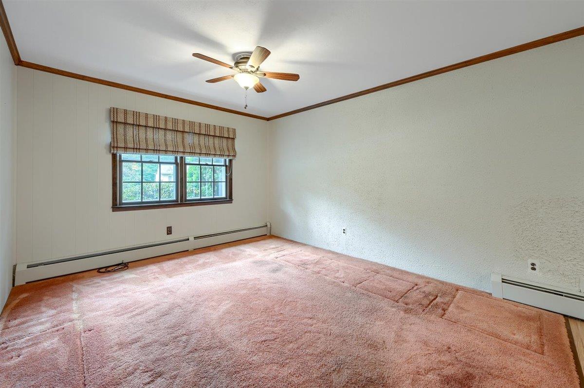 129 Barnes Road Washingtonville, NY 10992 - Photo 16 of 48 an empty room with a chandelier fan and windows