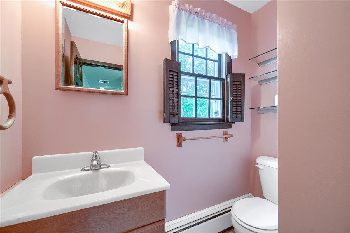 129 Barnes Road Washingtonville, NY 10992 - Photo 19 of 48 a bathroom with a sink toilet and mirror