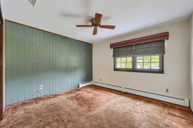 a view of a hallway with a livingroom and interior of the house