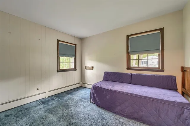 an empty room with a ceiling fan and a window