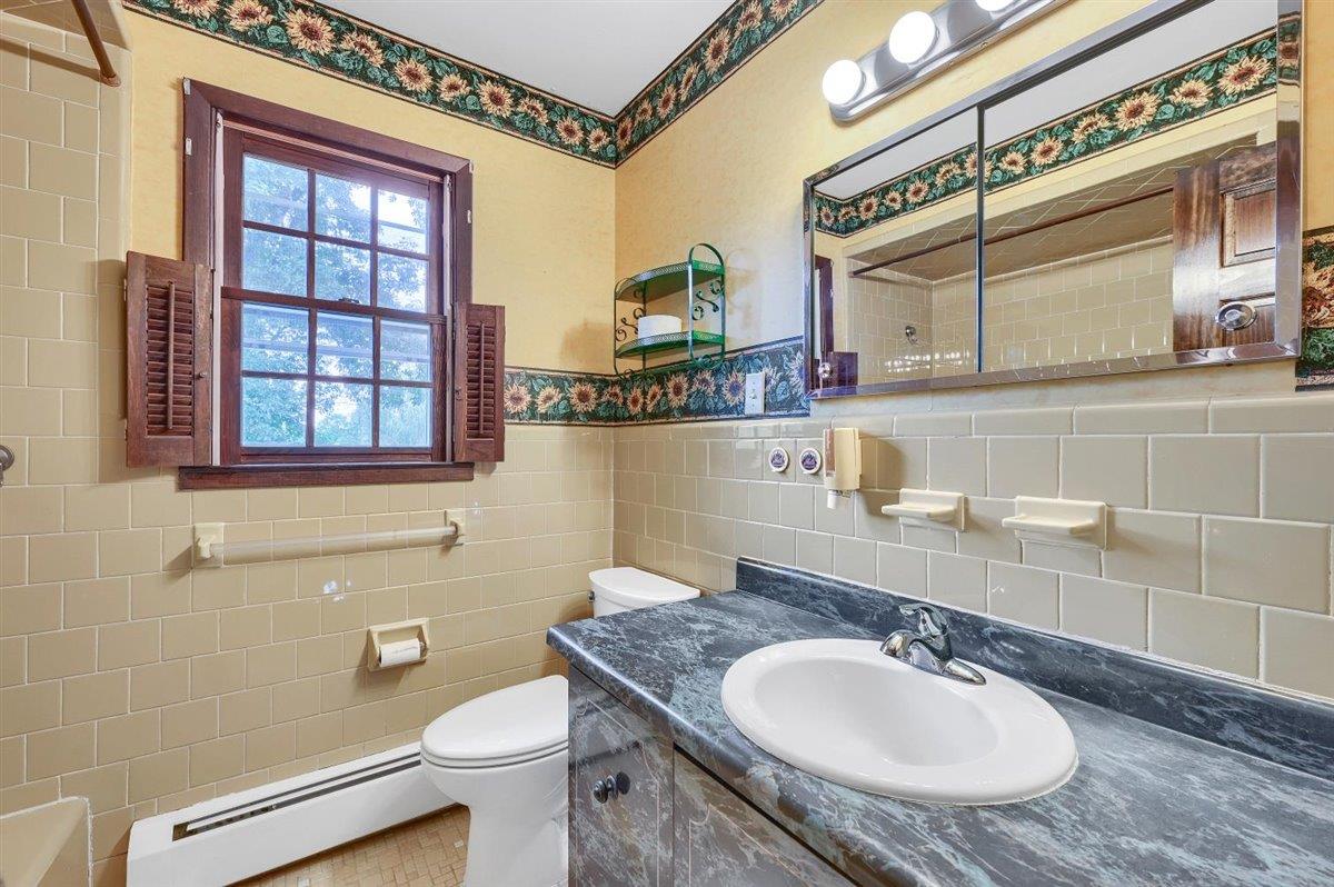 129 Barnes Road Washingtonville, NY 10992 - Photo 28 of 48 a bathroom with a granite countertop toilet sink and mirror