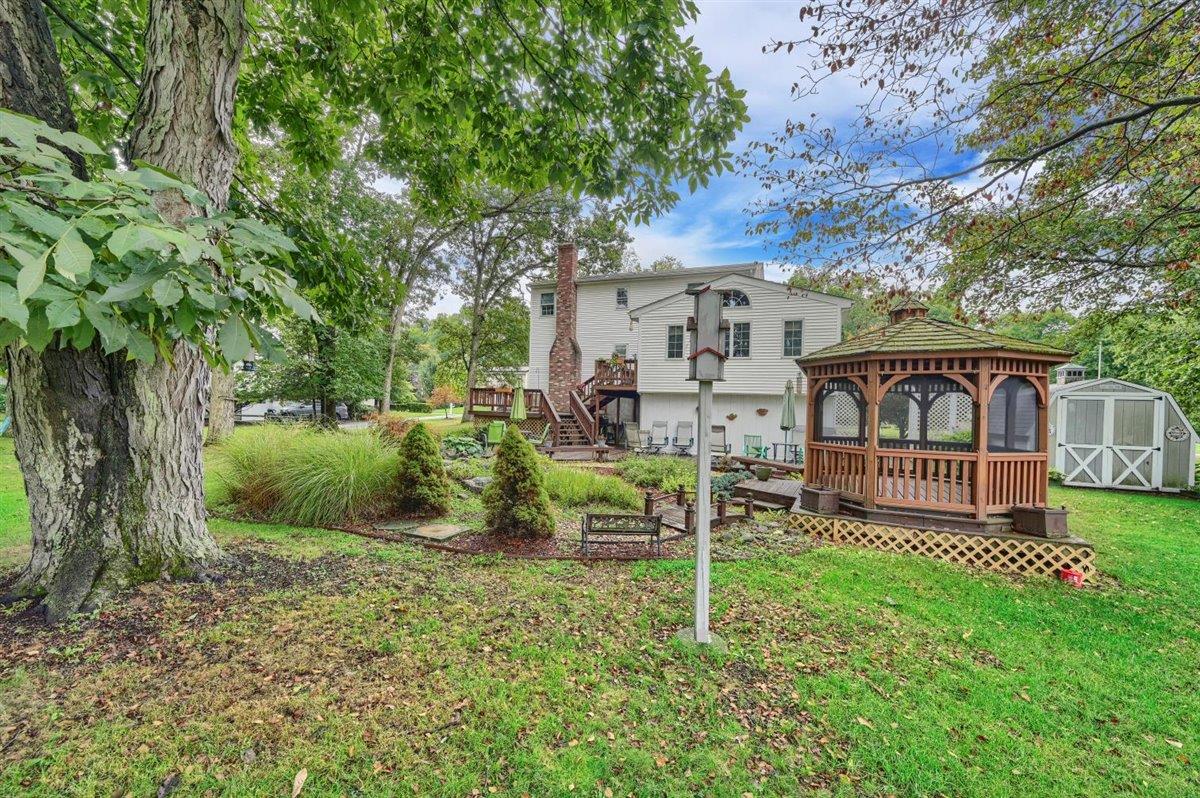 129 Barnes Road Washingtonville, NY 10992 - Photo 45 of 48 a view of a chair and table in backyard of the house