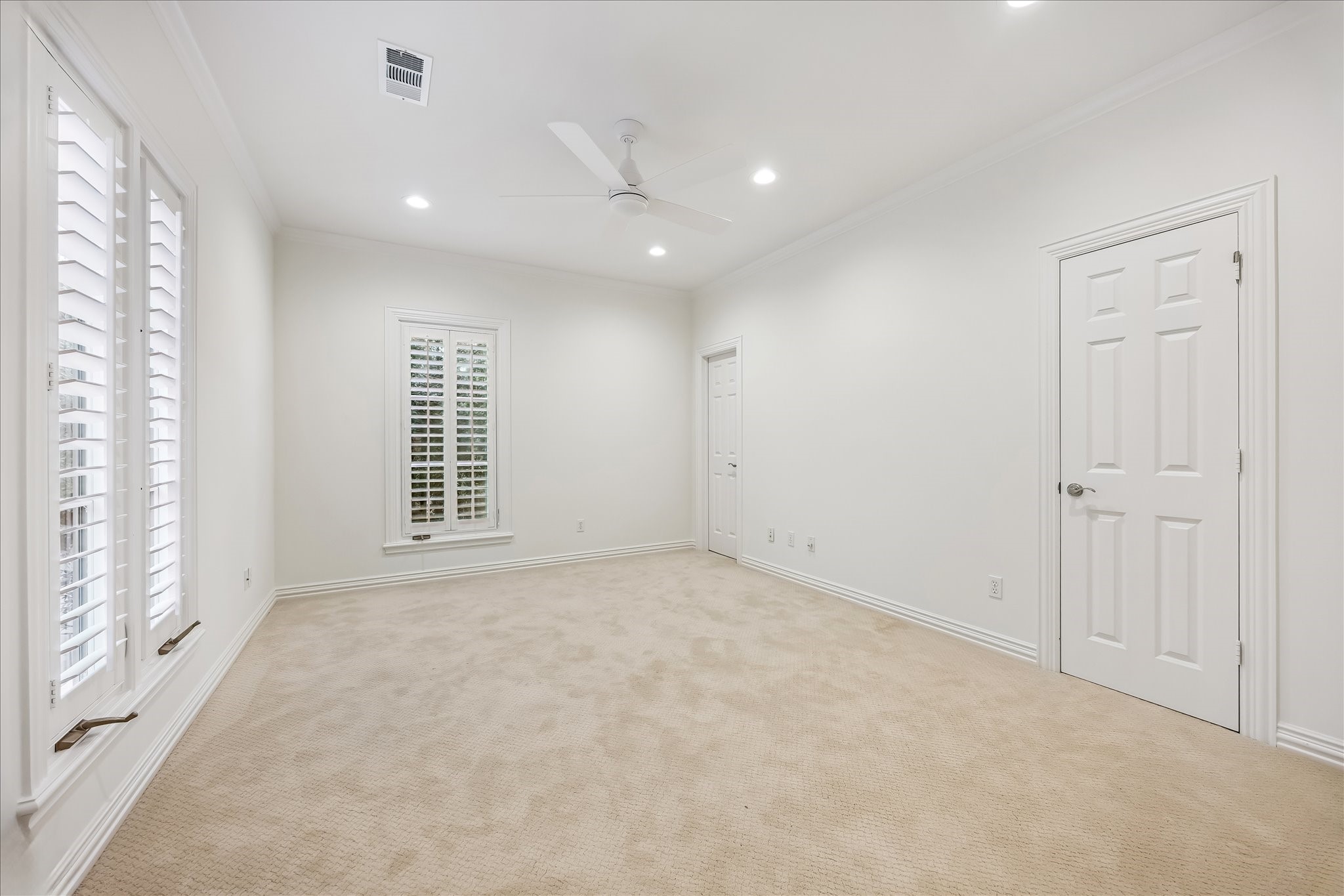 5034 Tangle Lane Houston, TX 77056 - Photo 31 of 50 The second secondary bedroom offers generous proportions with soft neutral carpeting, crown molding, recessed lighting, plantation-shuttered windows and substantial closet storage.