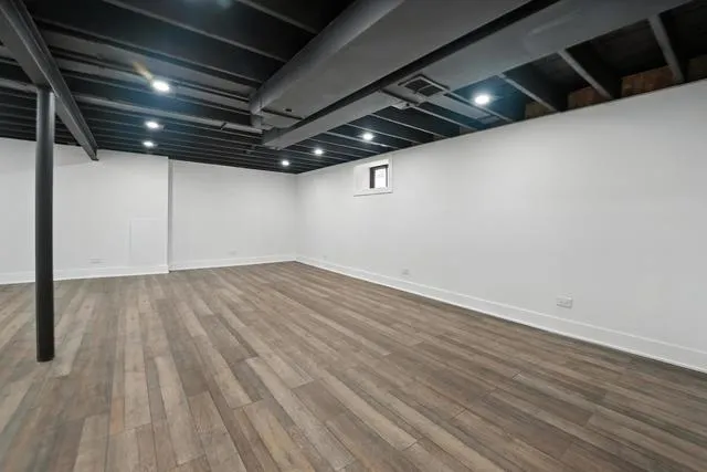 a view of a room with wooden floor