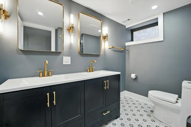a bathroom with a sink vanity and toilet
