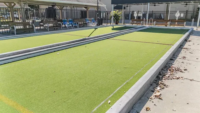 an aerial view of a house with a yard basket ball court and outdoor seating