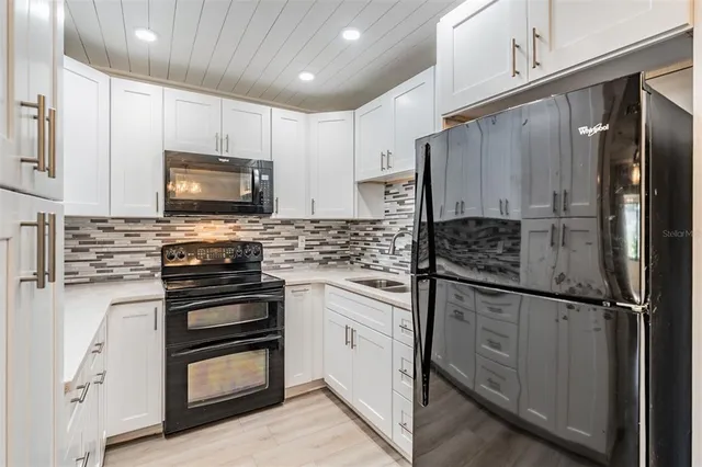 a kitchen with stainless steel appliances a refrigerator stove microwave and sink