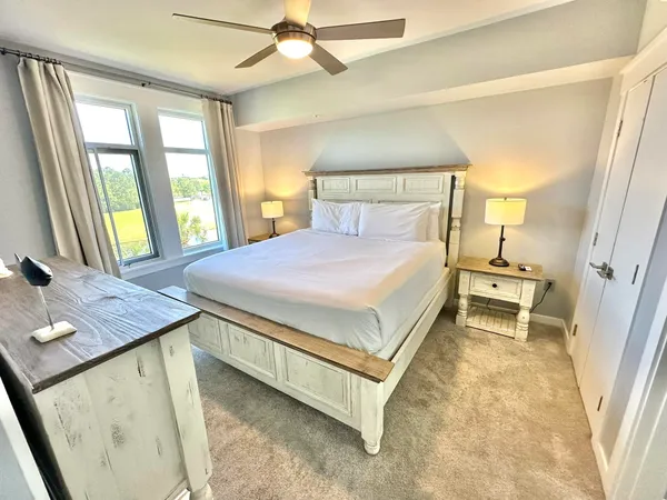a spacious bedroom with a bed and a dresser