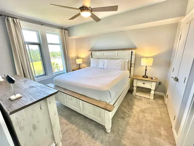 a spacious bedroom with a bed and a dresser