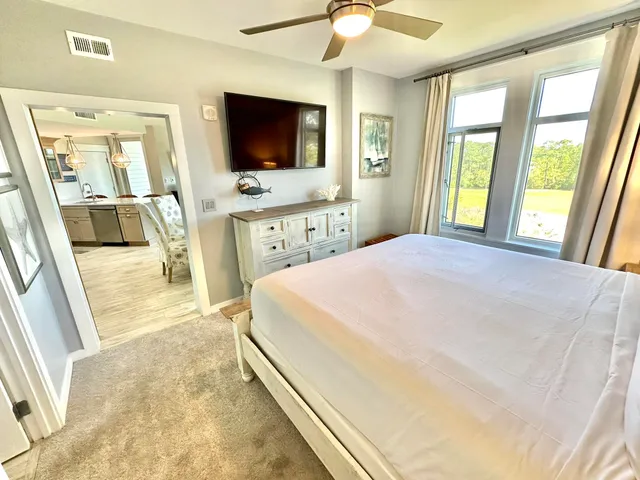 a bedroom with a bed and a flat screen tv