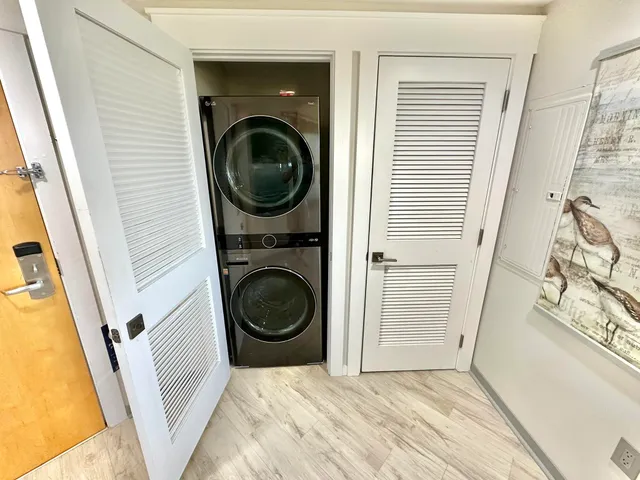 a view of swimming pool with seating space and trees in the background