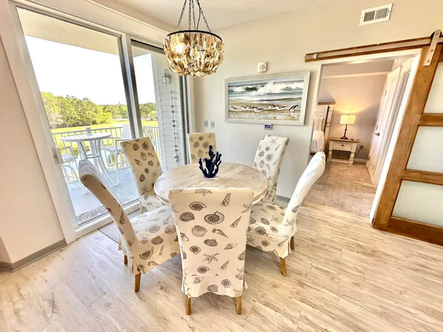 a view of a dining room with furniture wooden floor and chandelier
