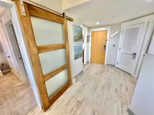 a kitchen with stainless steel appliances a dining table chairs and a refrigerator
