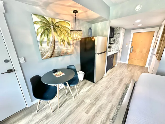 a bedroom with a bed a large window and flat screen tv