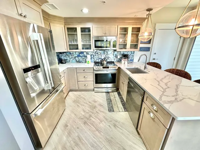 a kitchen with a sink stove and refrigerator