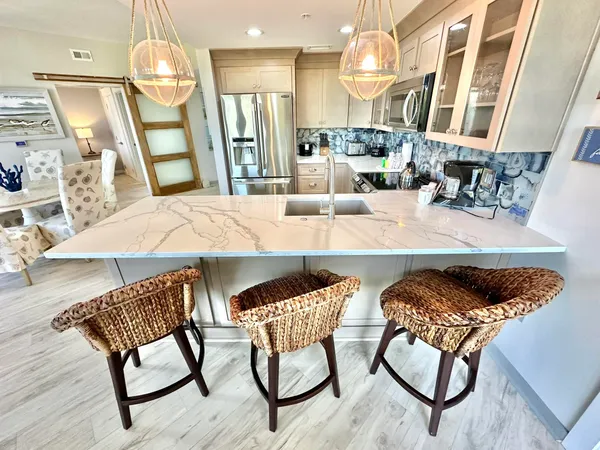 a view of a dining room with furniture and a chandelier