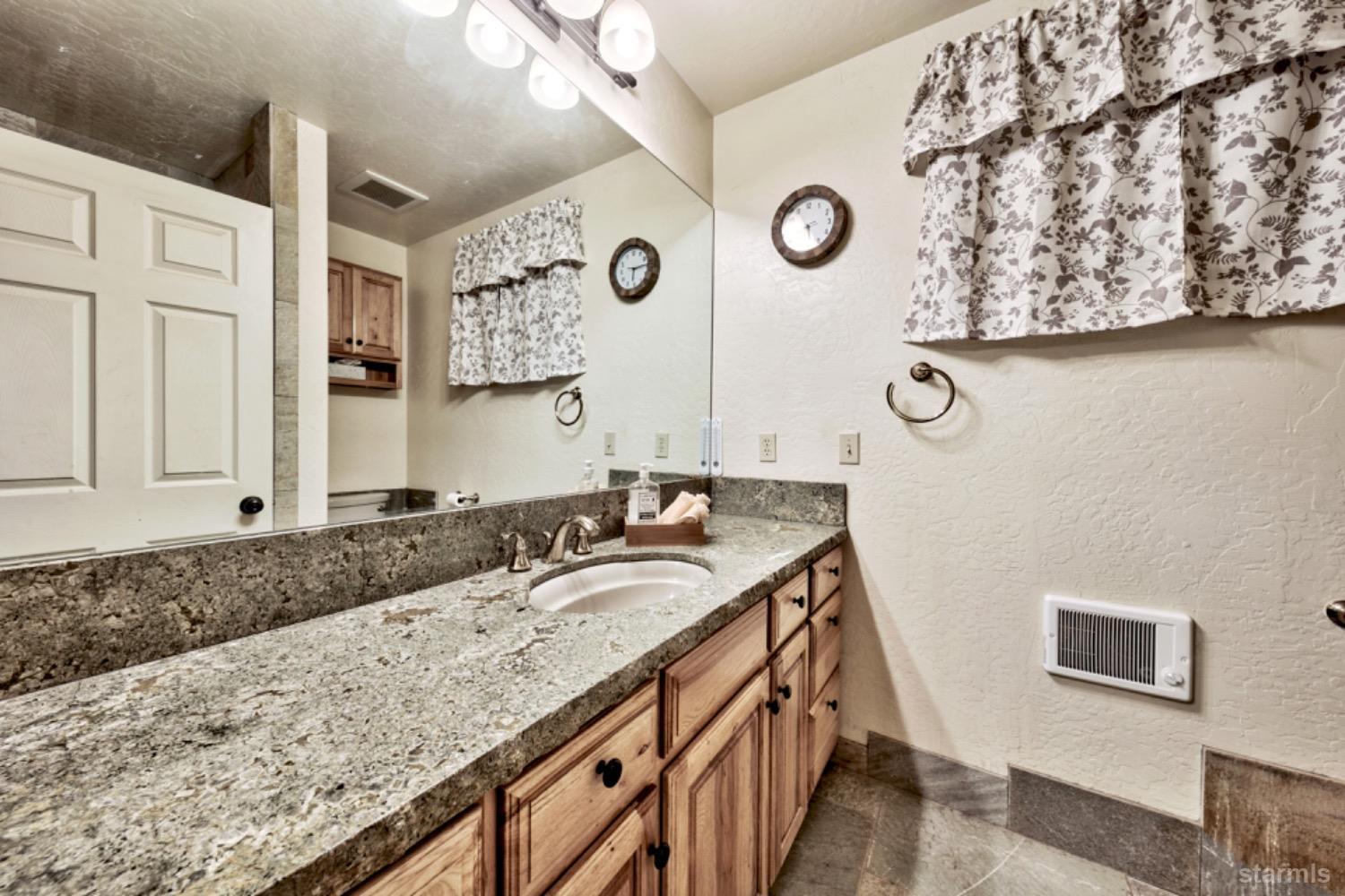 7000 Indian Creek Road Markleeville, CA 96120 - Photo 39 of 39 a bathroom with a granite countertop sink and a mirror