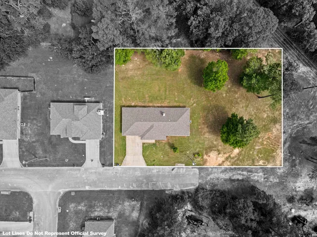 an aerial view of a residential houses with outdoor space