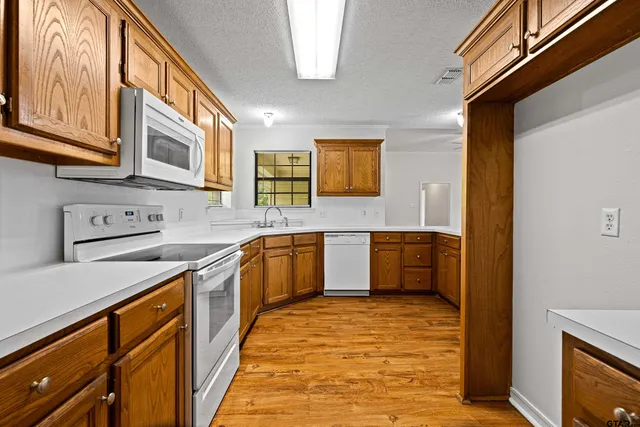 a kitchen with stainless steel appliances granite countertop a sink and cabinets