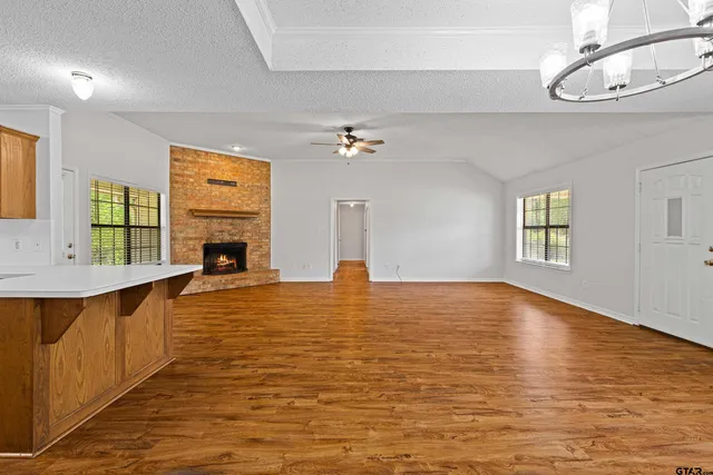 a view of empty room with wooden floor and window