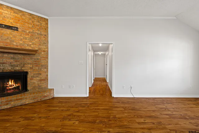 a view of empty room with window and fireplace