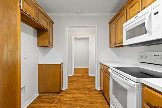 a kitchen with a sink and a stove top oven