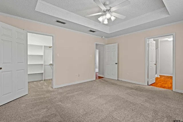 a view of an empty room with a ceiling fan