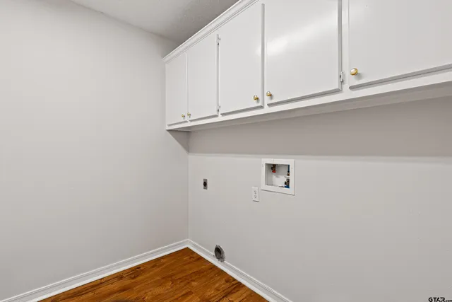 a view of a kitchen with white cabinets and a window